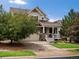 Inviting two-story home with a charming front porch and well-maintained landscaping at 11945 S Saunter Ln, Parker, CO 80138