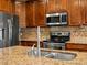Close up view of the kitchen with granite countertops, stainless steel appliances and tile backsplash at 11945 S Saunter Ln, Parker, CO 80138