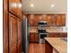 Wooden cabinets and stainless appliances highlight this full kitchen view at 11945 S Saunter Ln, Parker, CO 80138