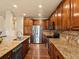 A full kitchen view showcases wooden cabinets, granite countertops, and stainless steel appliances at 11945 S Saunter Ln, Parker, CO 80138