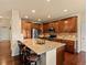Open kitchen with a large island, stainless steel appliances, and wooden cabinets at 11945 S Saunter Ln, Parker, CO 80138