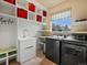 Well-organized laundry room with modern washer and dryer, sink, and ample storage at 11945 S Saunter Ln, Parker, CO 80138