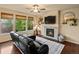 Comfortable living room featuring a stone fireplace, ample natural light, and modern décor at 11945 S Saunter Ln, Parker, CO 80138