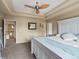 Spacious main bedroom boasts tray ceiling, fan, and neutral color palette at 11945 S Saunter Ln, Parker, CO 80138