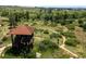 Scenic observation tower with a brown roof overlooking a green meadow landscape with walking trails at 11945 S Saunter Ln, Parker, CO 80138