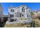 Back of the house with a concrete patio and green, well-kept lawn at 8441 Urban Ct, Arvada, CO 80005