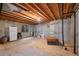 Spacious unfinished basement with cement walls, plywood floor and a small window at 8441 Urban Ct, Arvada, CO 80005