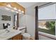 Well-lit bathroom featuring a double vanity, and a large window at 8441 Urban Ct, Arvada, CO 80005