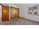 This bedroom has carpet, white walls, a window and a closet with sliding doors at 8441 Urban Ct, Arvada, CO 80005
