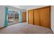 Bedroom featuring a big window, neutral carpet and sliding door closet at 8441 Urban Ct, Arvada, CO 80005