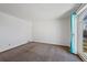 This bedroom features neutral carpet, light walls and a large window at 8441 Urban Ct, Arvada, CO 80005