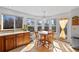 Bright breakfast nook featuring a round wood table, large windows, and sunny views at 8441 Urban Ct, Arvada, CO 80005