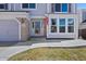 Inviting front entrance with brick accents and a well-lit pathway at 8441 Urban Ct, Arvada, CO 80005