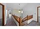 Hallway with wooden banister and an open view, leading to the house's other rooms at 8441 Urban Ct, Arvada, CO 80005