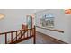 Bright hallway with wood banister and a large window offering natural light at 8441 Urban Ct, Arvada, CO 80005