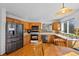 Bright eat-in kitchen with wood cabinets and stainless steel appliances at 8441 Urban Ct, Arvada, CO 80005