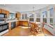 Eat-in kitchen featuring wood cabinets and natural light at 8441 Urban Ct, Arvada, CO 80005
