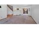 Open-concept living area with neutral carpet and stylish lighting at 8441 Urban Ct, Arvada, CO 80005