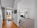 Open-concept living area with hardwood floors flowing into a carpeted living room at 8441 Urban Ct, Arvada, CO 80005