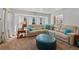Comfortable living room featuring a large sectional sofa and neutral carpet at 8441 Urban Ct, Arvada, CO 80005