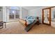 Serene main bedroom with a sleigh bed, large windows, and access to a private door at 8441 Urban Ct, Arvada, CO 80005