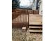 Spacious wooden backyard deck featuring wood railing and stairs leading to a pebble walkway at 8769 S Dudley St, Littleton, CO 80128