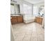 Bright bathroom with double vanities, a soaking tub under a window and tile flooring at 8769 S Dudley St, Littleton, CO 80128