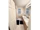 Bathroom with double sinks, granite countertops, tile floor, and neutral paint at 8769 S Dudley St, Littleton, CO 80128
