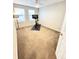 This bedroom is currently being used as a workout room and has a ceiling fan and two windows at 8769 S Dudley St, Littleton, CO 80128