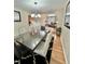 Elegant dining room with a large table, stylish chairs, and a view into the living room at 8769 S Dudley St, Littleton, CO 80128
