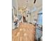 Bright foyer with hardwood floors, a staircase, and views of the living area and upper level at 8769 S Dudley St, Littleton, CO 80128