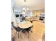 Open kitchen with wood cabinets, granite countertops, stainless steel appliances, and an adjacent dining area at 8769 S Dudley St, Littleton, CO 80128