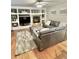 Comfortable living room area featuring a fireplace with shelving, a sectional sofa, hardwood flooring and an area rug at 8769 S Dudley St, Littleton, CO 80128