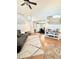 Spacious living room with high ceilings, hardwood floors, open layout, and a view into the dining room at 8769 S Dudley St, Littleton, CO 80128