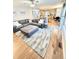 Bright living room featuring a comfortable sectional sofa, area rug on hardwood floors and adjacent open-concept kitchen at 8769 S Dudley St, Littleton, CO 80128