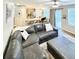 Open-concept living room featuring a large sectional sofa, a ceiling fan and an adjacent kitchen and dining area at 8769 S Dudley St, Littleton, CO 80128