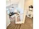 View from the staircase of the living room with hardwood floors, a ceiling fan, and natural light at 8769 S Dudley St, Littleton, CO 80128