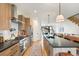 Bright kitchen featuring a large island with seating and stainless steel appliances at 2453 Chase St, Edgewater, CO 80214