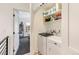 This modern laundry area has a washer and dryer plus shelving for storage at 2453 Chase St, Edgewater, CO 80214