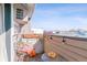 Cozy outdoor balcony featuring a wicker chair, small table, string lights and views at 10150 E Virginia Ave # 19-303, Denver, CO 80247