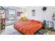 Spacious bedroom with large bed and yellow armchair at 10150 E Virginia Ave # 19-303, Denver, CO 80247