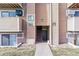 Exterior shot of an apartment building entrance showing unit numbers, stairs, and landscaping at 10150 E Virginia Ave # 19-303, Denver, CO 80247