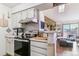 A bright living room with a stone accent wall, open to the kitchen, and a sliding door to the balcony at 10150 E Virginia Ave # 19-303, Denver, CO 80247