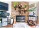 Cozy living room featuring a stone fireplace, wooden shelves, modern decor, and comfortable seating at 10150 E Virginia Ave # 19-303, Denver, CO 80247
