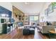 Inviting living room with a stone accent wall, fireplace, balcony access, and comfortable furniture at 10150 E Virginia Ave # 19-303, Denver, CO 80247