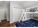 A bedroom featuring a bunk bed with shelving and a closet at 3043 W 109Th Pl, Westminster, CO 80031