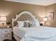 Charming bedroom featuring a stylish upholstered bed, decorative pillows and warm, neutral wall color at 3043 W 109Th Pl, Westminster, CO 80031