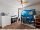 Spacious bedroom with ceiling fan, dresser, open shelving, and an underwater themed play tent at 3043 W 109Th Pl, Westminster, CO 80031