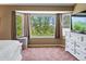 Bright bedroom showcases a large bay window with treetop views and a beautiful white dresser at 3043 W 109Th Pl, Westminster, CO 80031