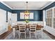 Chic dining room with blue walls, white wainscoting, and a stylish modern chandelier at 3043 W 109Th Pl, Westminster, CO 80031